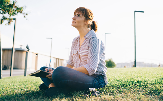 woman sitting on grass thinking